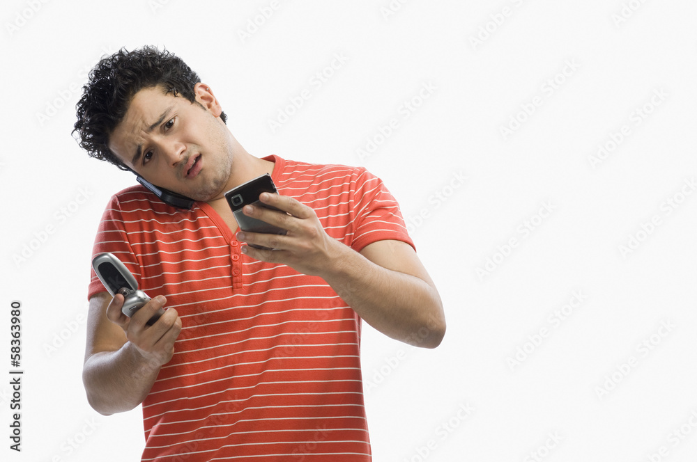 Man using multiple mobile phones Man using multiple mobile phones