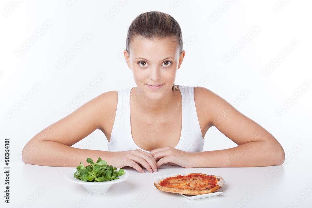 Woman choosing between salade and pizza Woman choosing between salade and pizza