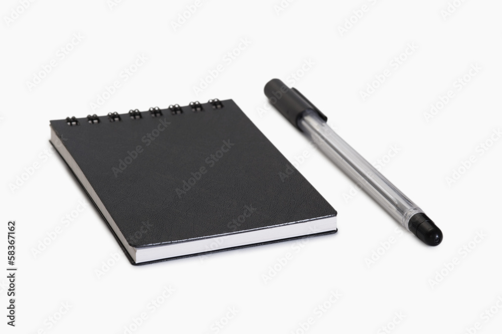 Close-up of a pen with a spiral notebook Close-up of a pen with a spiral notebook