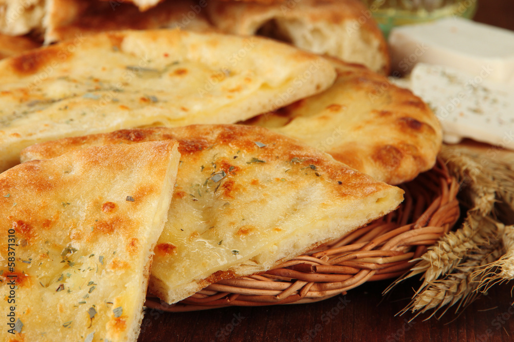 Pita breads with cheese on table close up