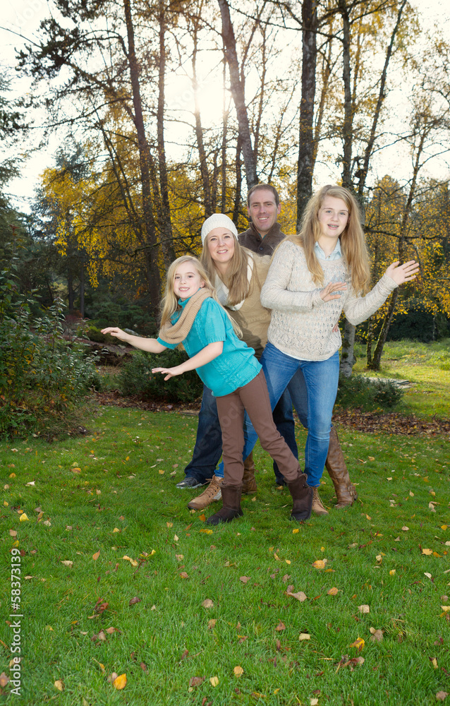 Fototapeta premium Family Dancing during a nice Autumn Day in the park