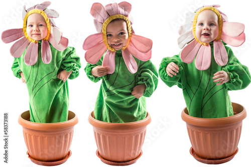 Collage of adorable baby boy and girl, dressed in flower costume
