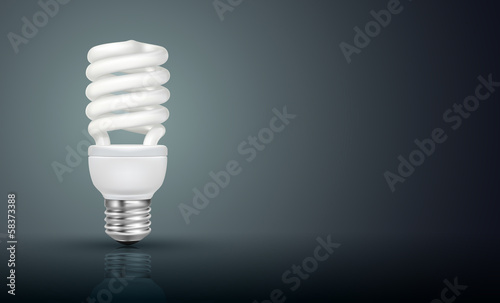 White energy saving lamp on black background