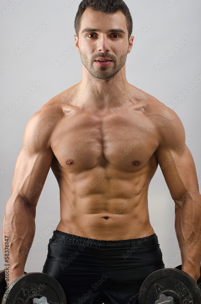 Bodybuilder training with heavy dumbbells Bodybuilder training with heavy dumbbells
