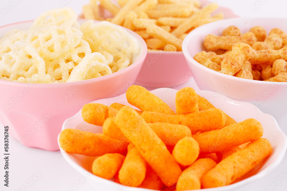 Potato, corn and wheat chips in bowls Potato, corn and wheat chips in bowls