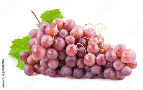 Fresh red grapes with leaves. Isolated on white
