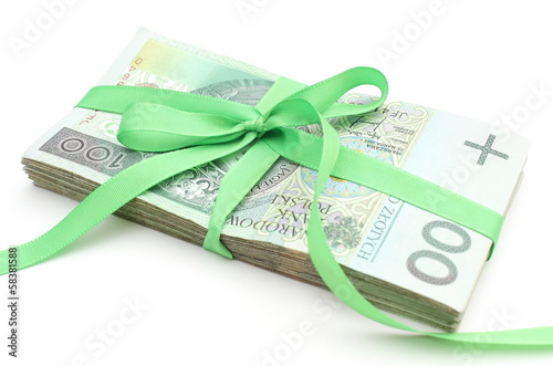 Pile of banknotes with green ribbon. White background