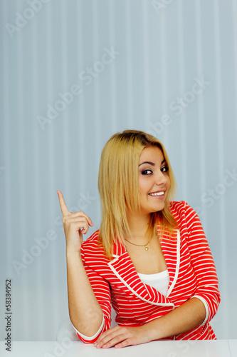 Happy young woman sitting at the table 