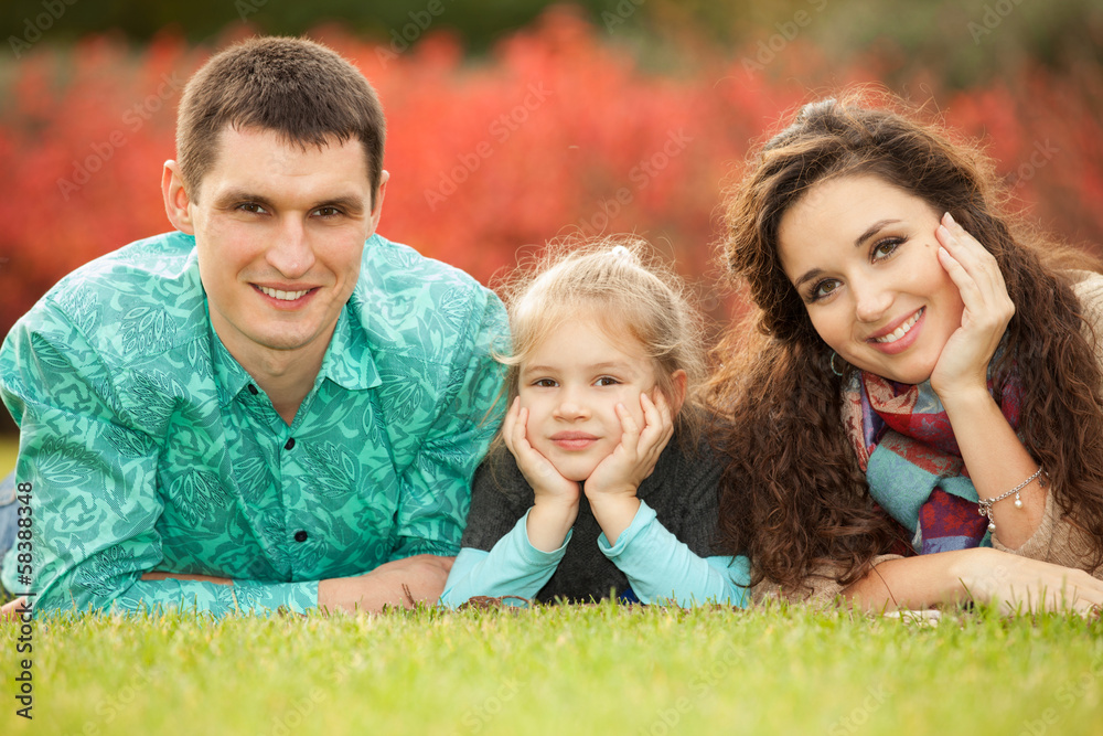 Happy mother, father and daughter in the park Happy mother, father and daughter in the park