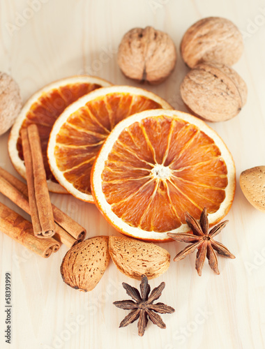 Fototapeta Naklejka Na Ścianę i Meble -  Dried orange slices with cinnamon and nuts