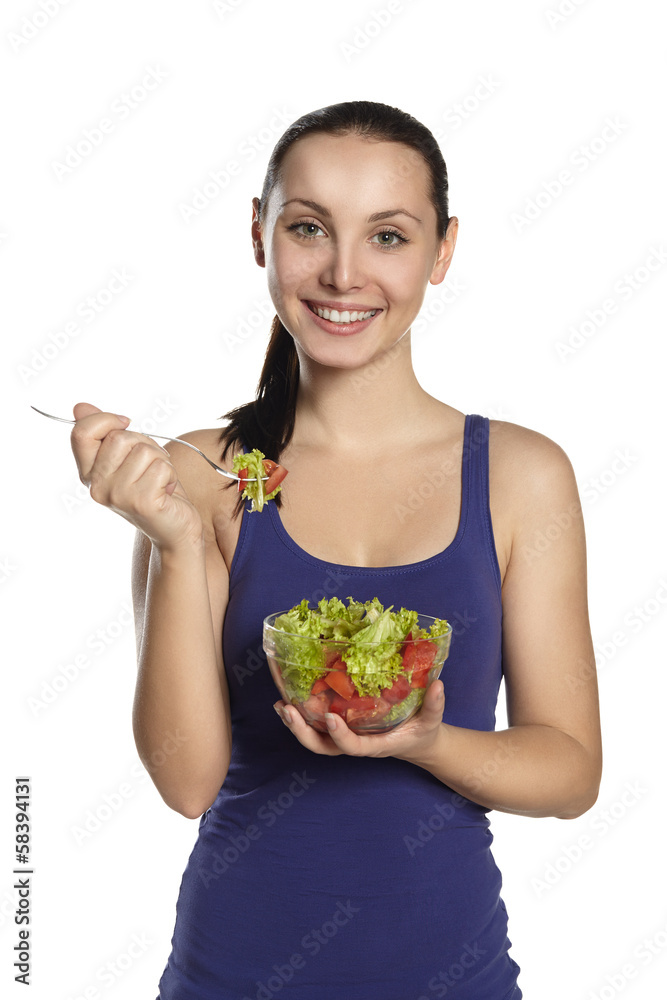 Young girl stands with a salad and smiling Young girl stands with a salad and smiling