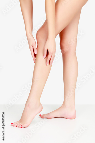 Female legs and hands, white background © Nobilior