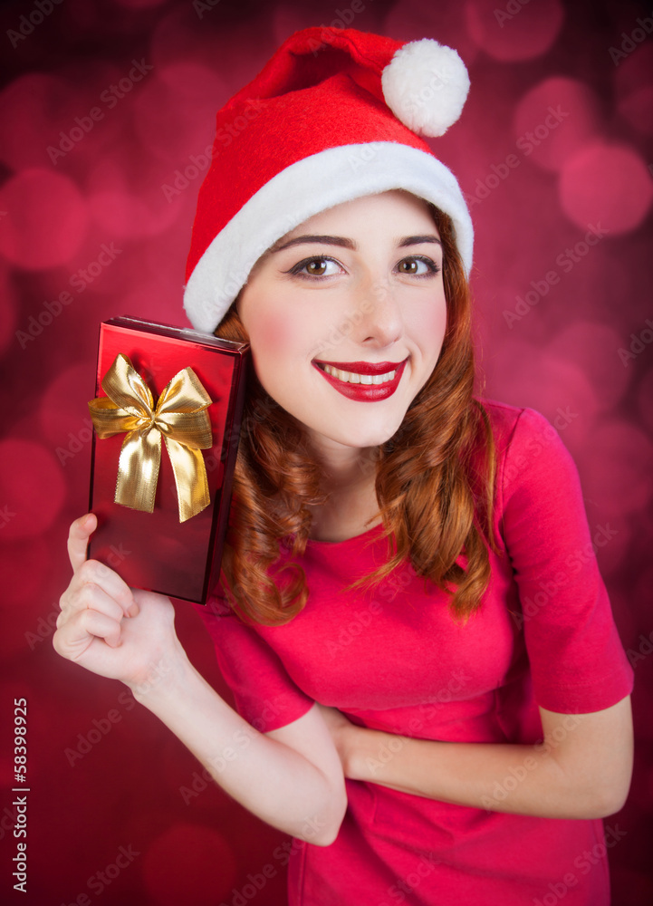 Redhead girl with gifts on red background Redhead girl with gifts on red background