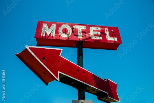Vintage, neon, red hotel sign with a red arrow