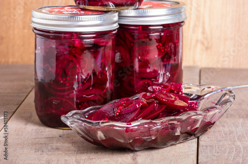 Pickled beets in jars and bowl
