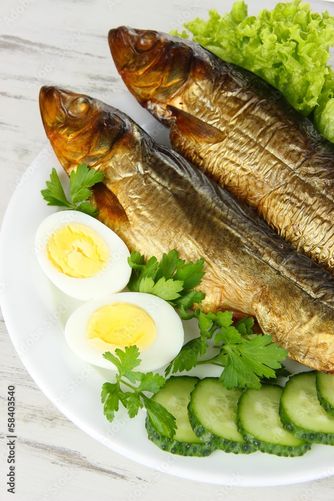 Smoked fish on plate close up