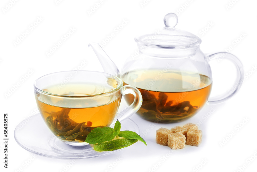 Cup and teapot of green tea with mint and sugar isolated Cup and teapot of green tea with mint and sugar isolated