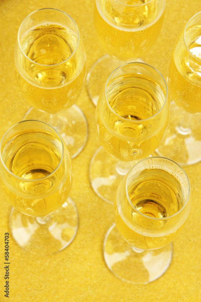 Glasses with champagne on shiny background Glasses with champagne on shiny background