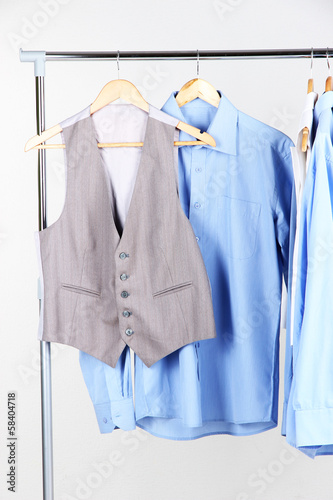 Office clothes on hangers, on gray background © Africa Studio