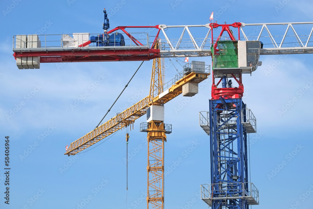 Closeup Of Tower Cranes At A Construction Site Closeup Of Tower Cranes At A Construction Site