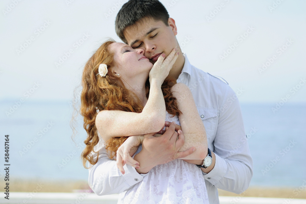 beautiful young couple in love near the sea