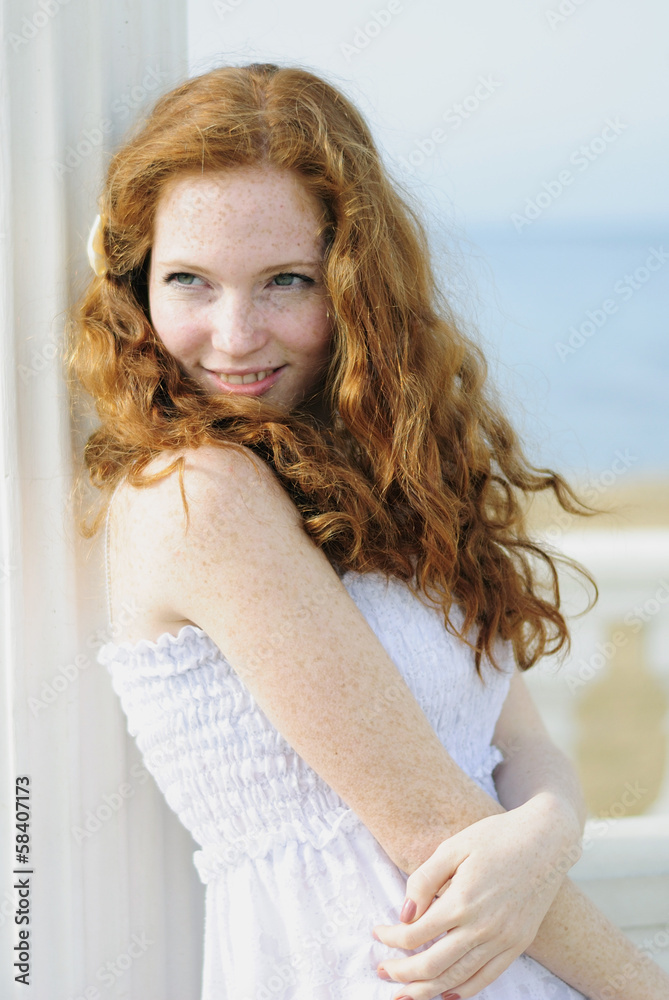 beautiful red-haired girl near the sea