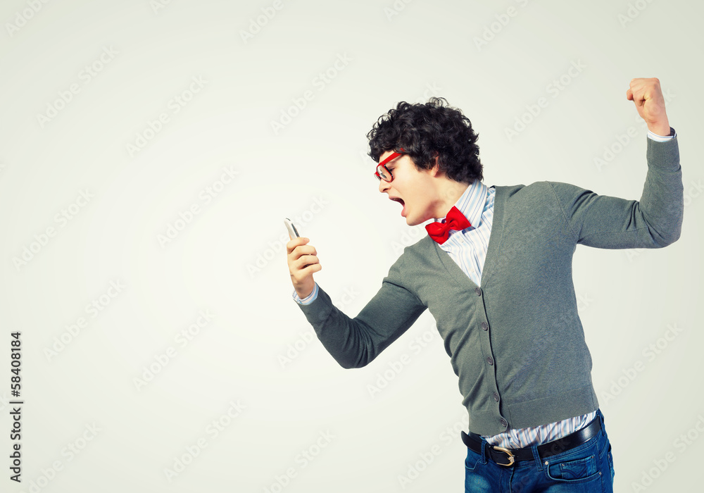 Young man shouting at his mobile phone Young man shouting at his mobile phone