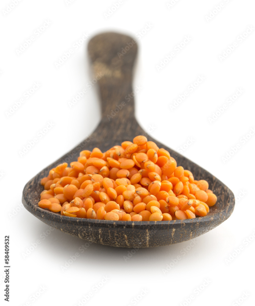 red lentils in a wooden scoop on white background red lentils in a wooden scoop on white background