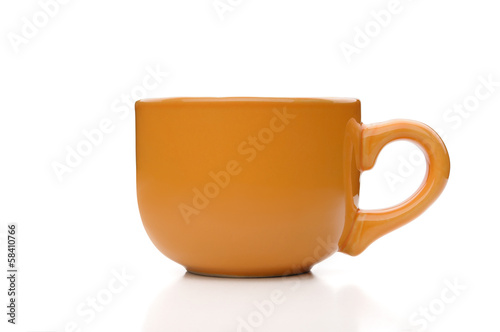 A simple orange tea cup viewed from profile, isolated on white background