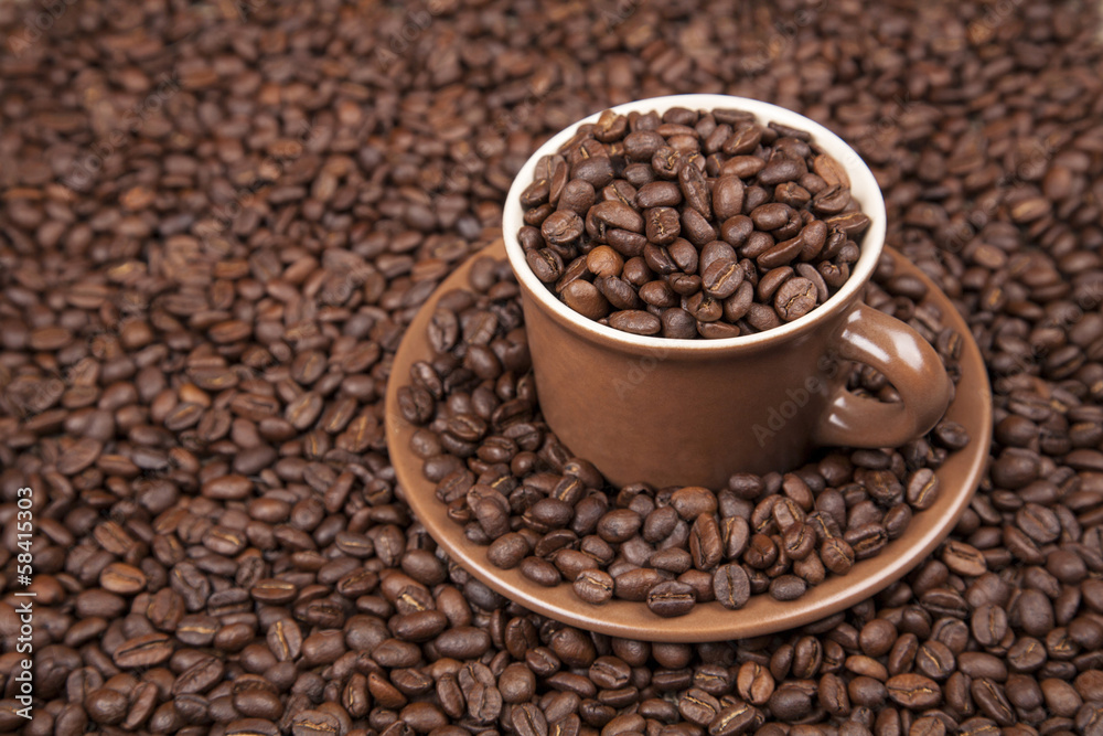Brown cup with coffee on coffee beans Brown cup with coffee on coffee beans