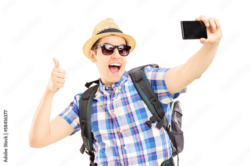 Male tourist taking pictures of himselves and giving thumb up Male tourist taking pictures of himselves and giving thumb up