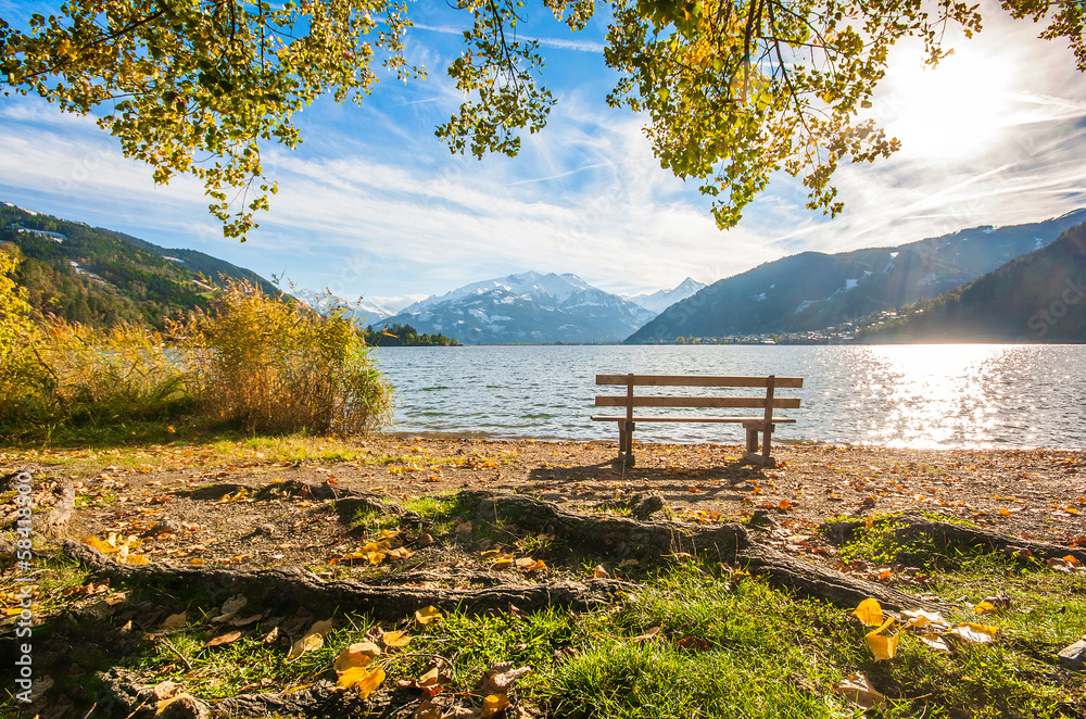 Beautiful autumn scene with bench at lake, Zell am See, Austria