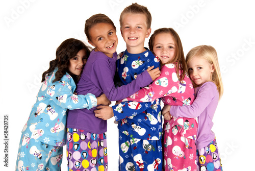 children hugging in holiday christmas pajamas