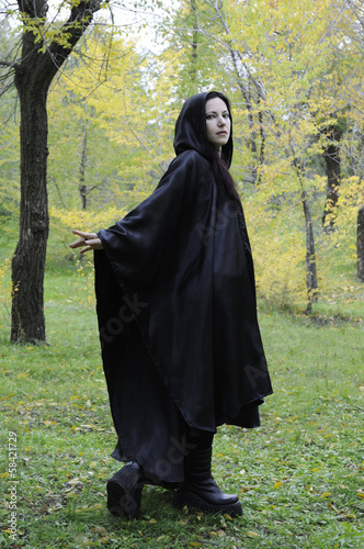Fotografie Black hooded dryad woman in the autumn forest