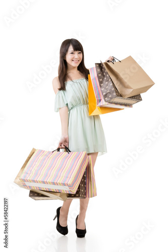 Attractive asian woman holding shopping bags