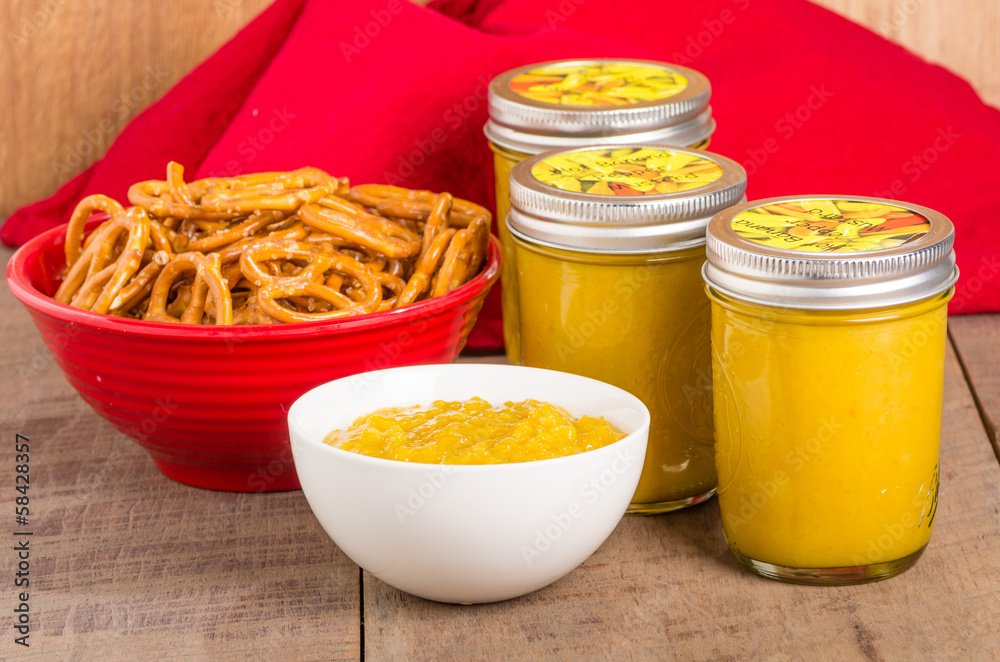Jars of homemade mustard with pretzels Jars of homemade mustard with pretzels