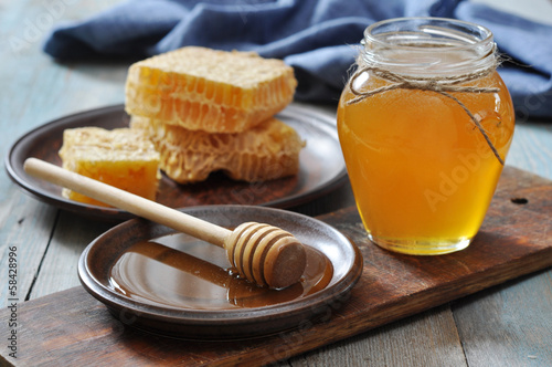 Honey in jar with honeycombs