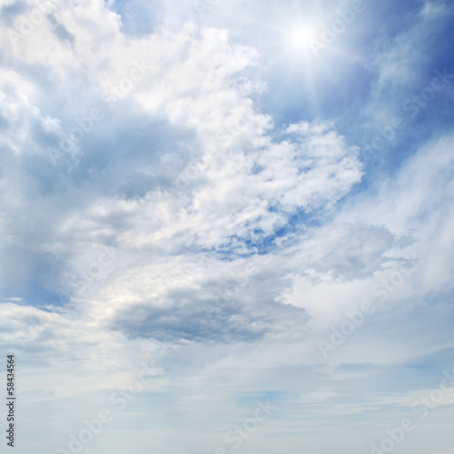 sun on blue sky with white clouds