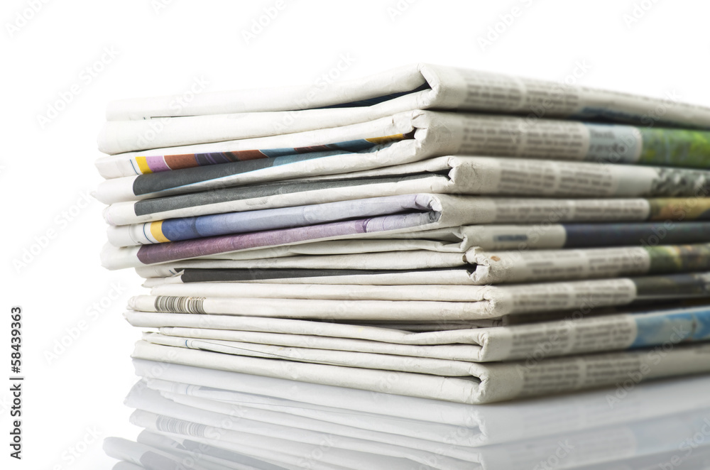 Pile of Various newspapers over white background. Pile of Various newspapers over white background.