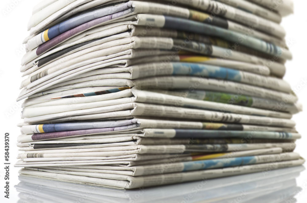 Pile of Various newspapers over white background. Pile of Various newspapers over white background.