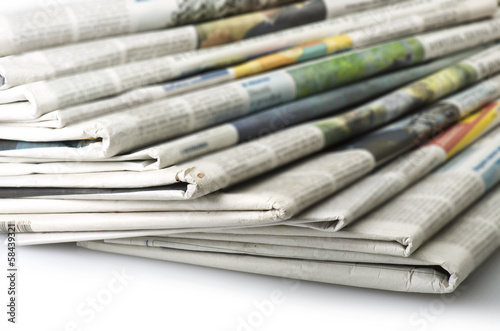 Pile of Various newspapers over white background. photo