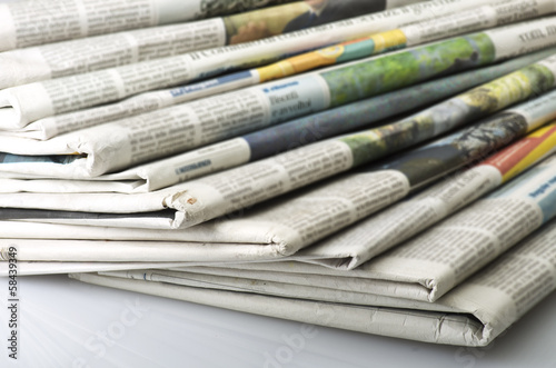 Pile of Various newspapers over white background. photo