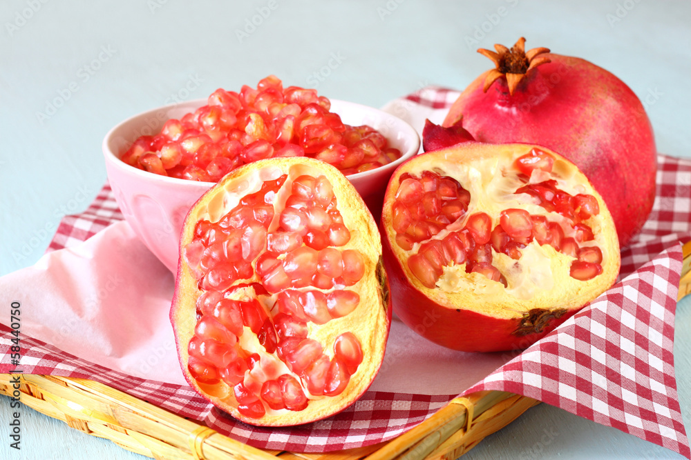 pomegranate on wooden table, and fresh pomegrante seed in bowl pomegranate on wooden table, and fresh pomegrante seed in bowl
