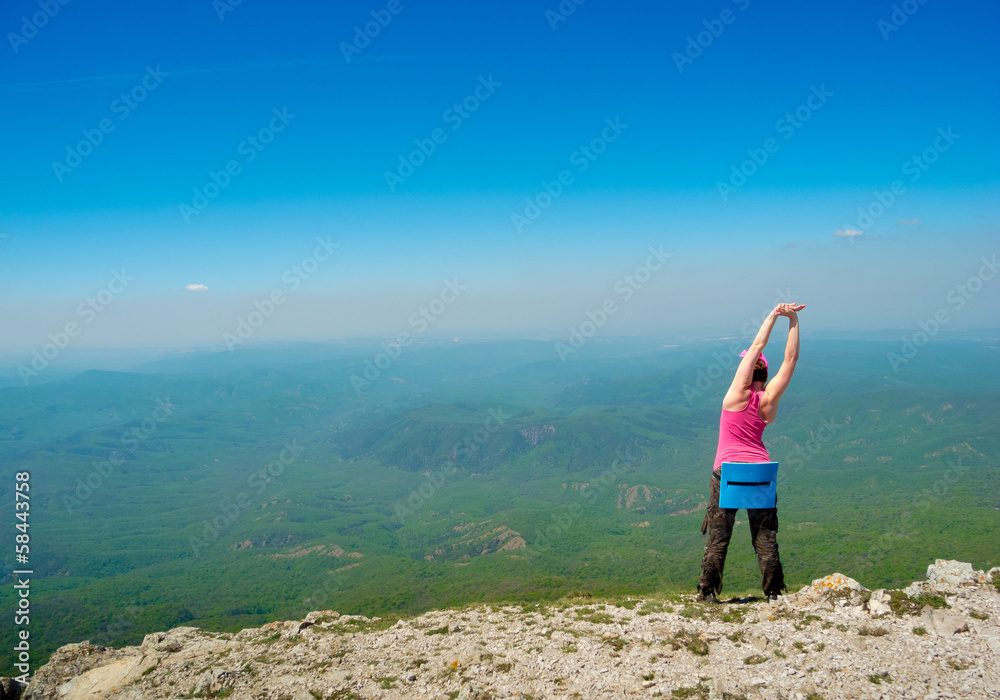 Woman stretching in mountains
