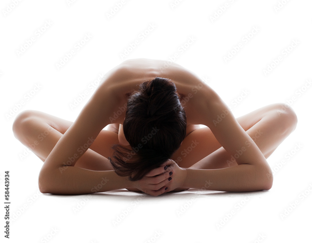 Fototapeta premium Close-up of slim naked girl meditates in studio