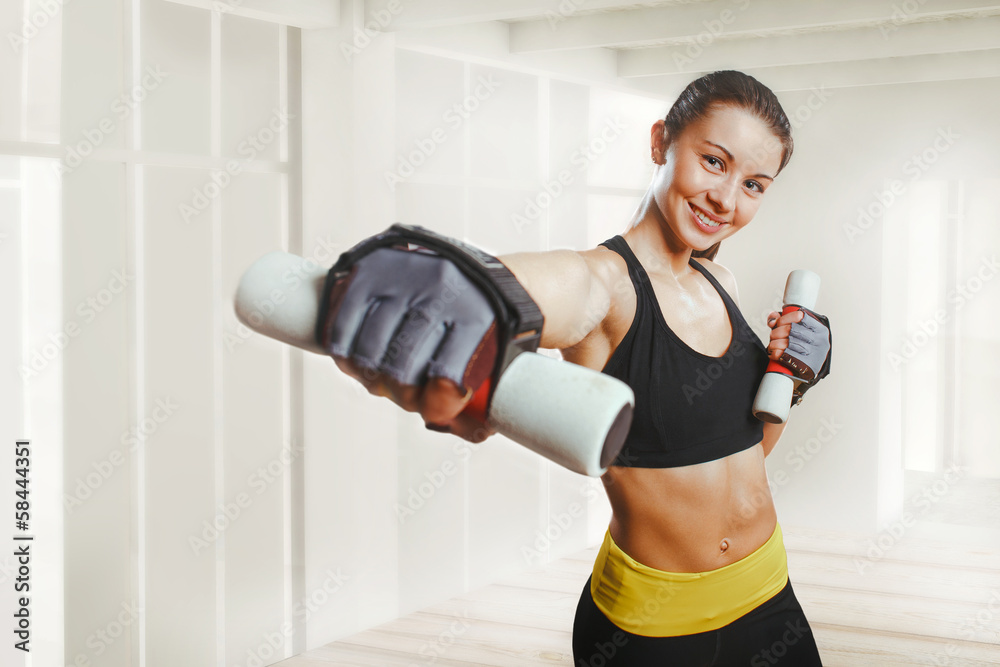 Happy woman working out with dumbbells Happy woman working out with dumbbells