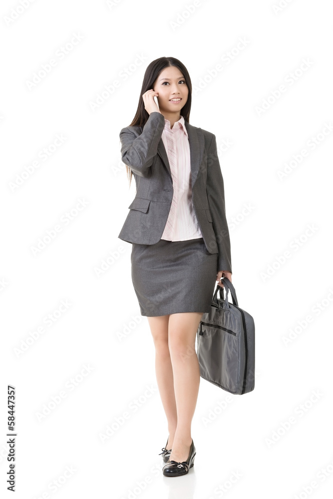 Asian business woman talking on the cell phone Asian business woman talking on the cell phone