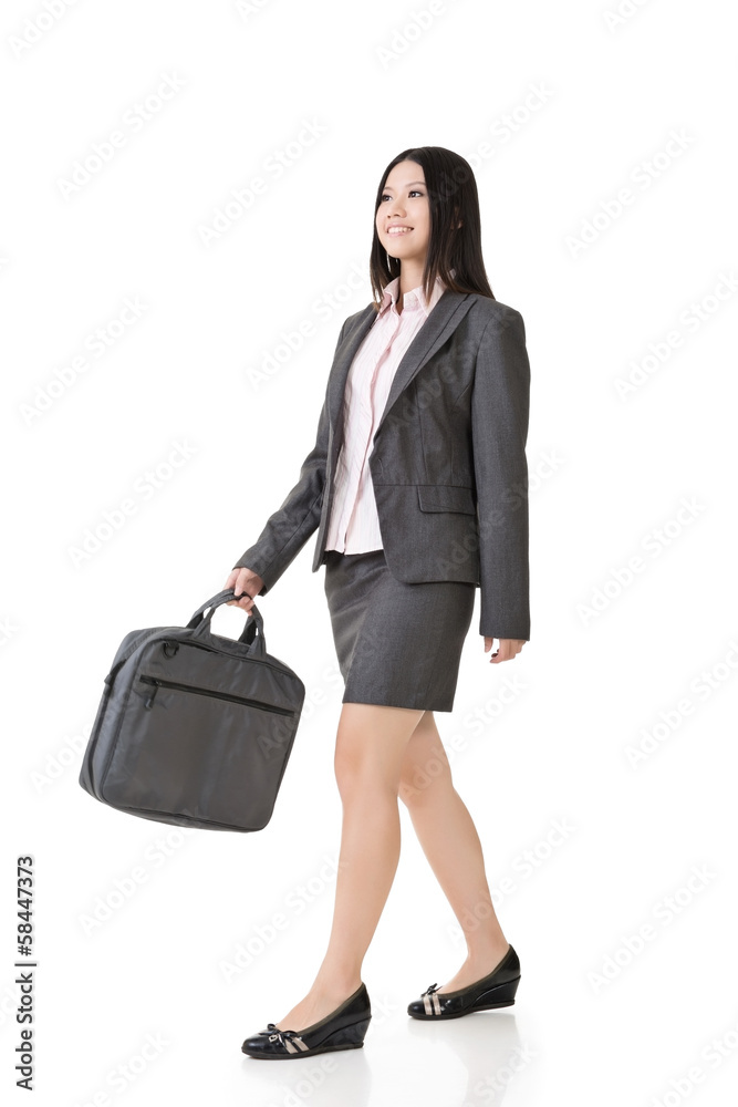 Asian businesswoman walking with a handbag Asian businesswoman walking with a handbag