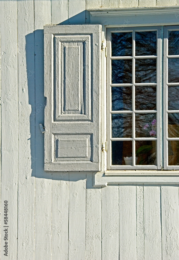 Exterior of gray building with window and its shutter. Exterior of gray building with window and its shutter.