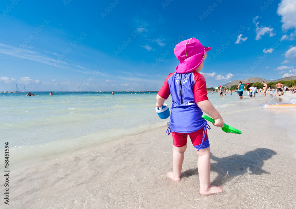 Kid on beach looking away from camera Kid on beach looking away from camera